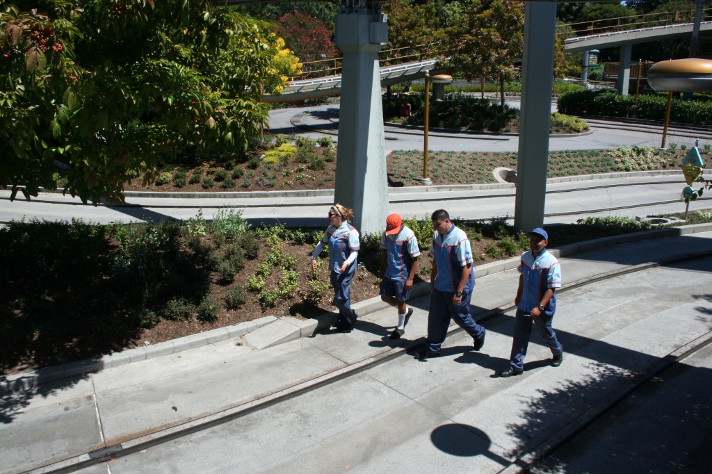 Cast members walk the Autopia track