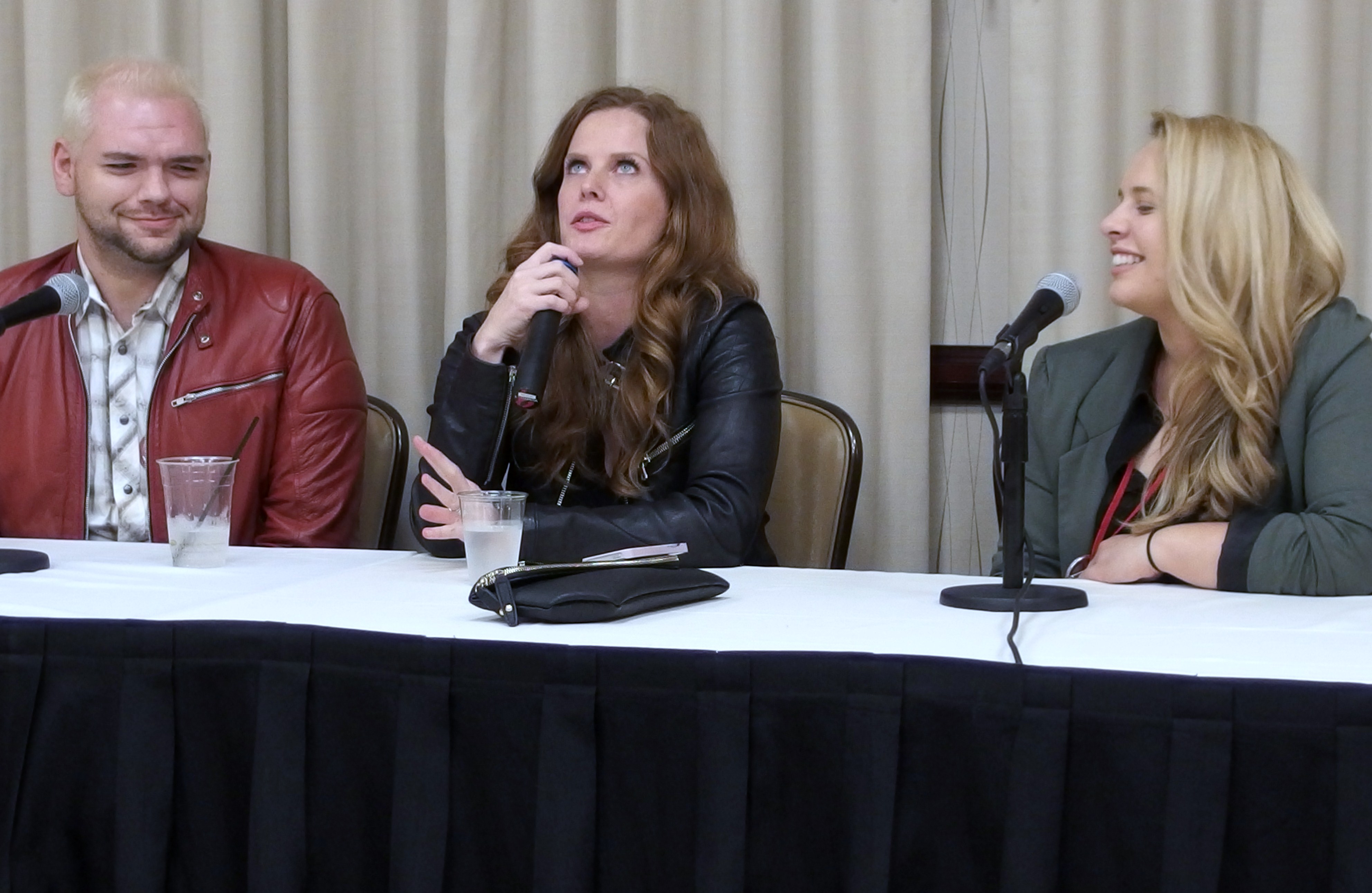 Zach van Norman and Liz Schleder flank Rebecca Mader during a press gathering