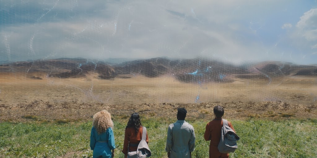 (L to R: Robyn Alomar (Aliyah), Humberly González (Brooklyn), Akiel Julien (Bohdi), and  Phillip Lewitski (Apollo) stand in front of The Shield surrounding New Babyl.  Photo Courtesy: Sonar Entertainment/Hulu)