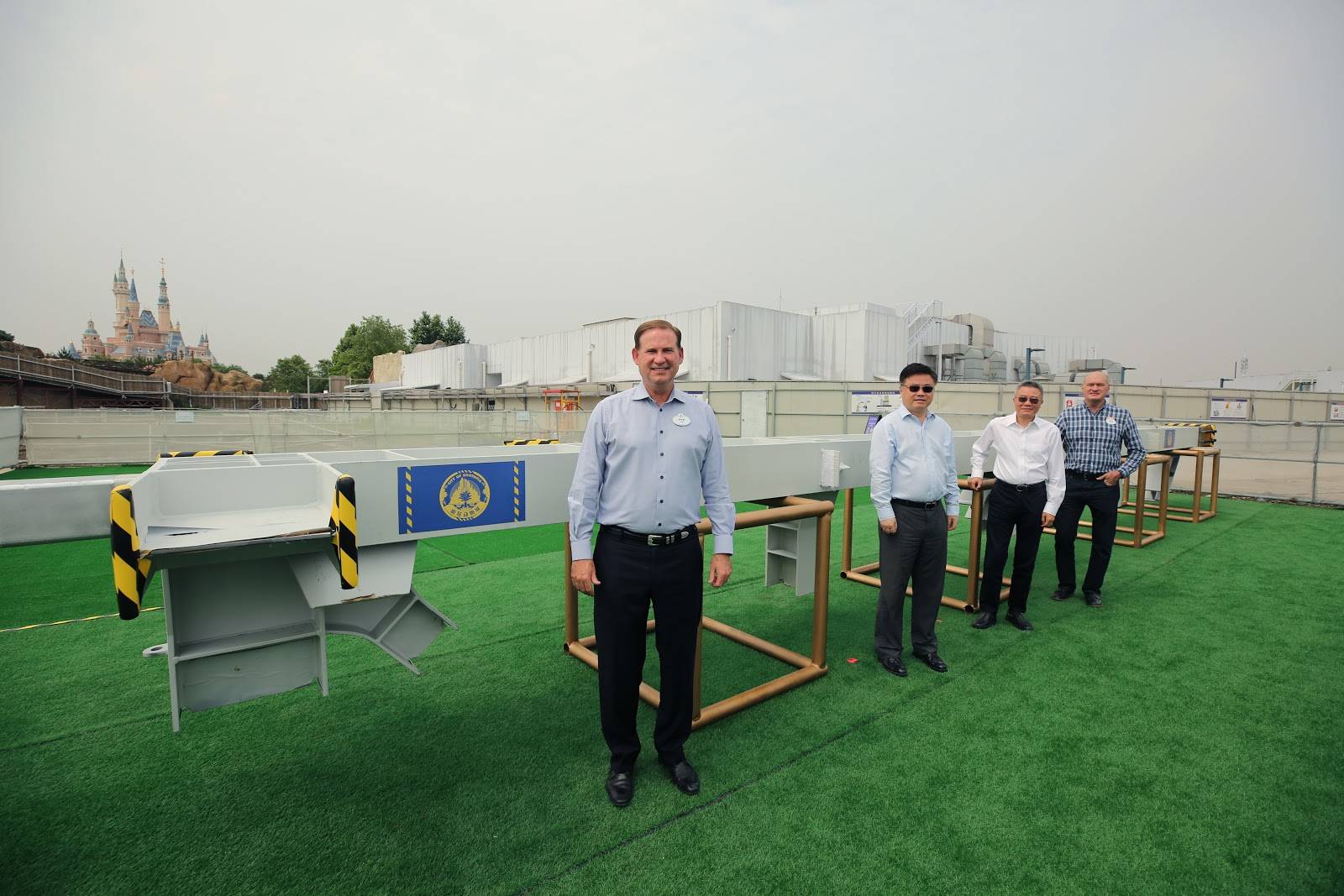 Joe Schott (first from left), Yang Jinsong, Li Guirong, and Tim Warzecha gathered to mark the historic occasion by signing the first steel column of Zootopia-themed land.