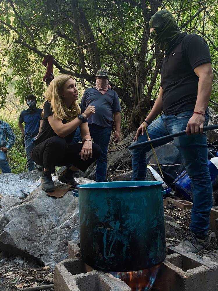 TRAFFICKED WITH MARIANA VAN ZELLER, one of Nat Geo's highest rated-series that delves deep inside global trafficking networks to understand how they operate and their impact on our world.  Mariana van Zeller (L) talking with a masked individual during production of an episode about meth. (Credit: National Geographic)