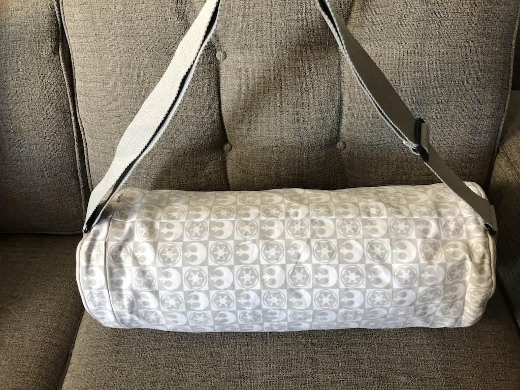 Carrying bag has an adjustable shoulder strap. Decoration includes Rebel and Imperial insignias.