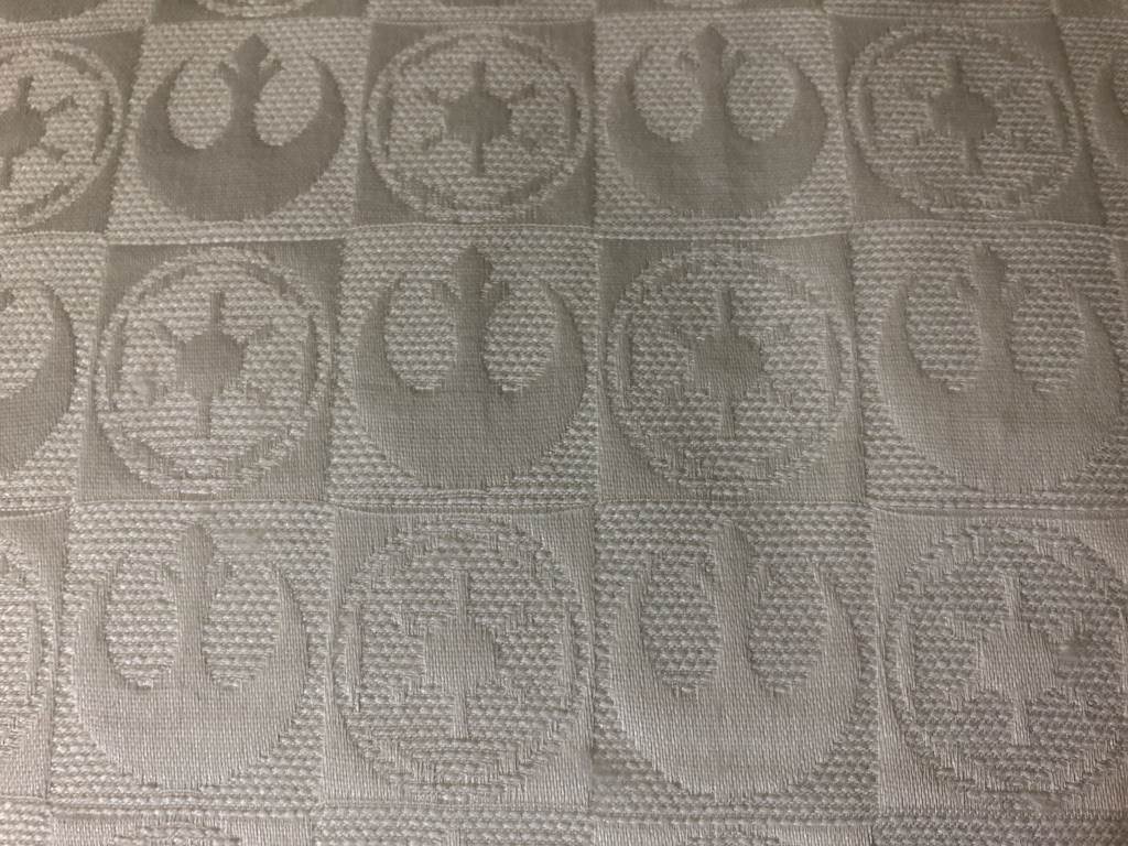 Rebel and Imperial symbols are featured on the cotton pillow cover.