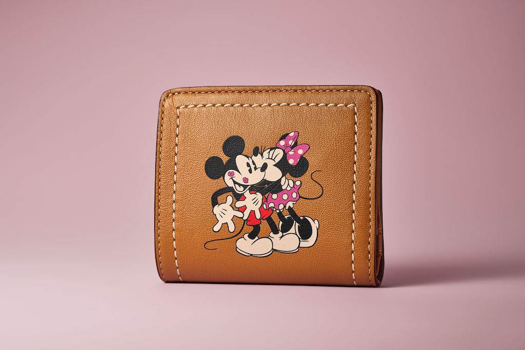 Bi-fold snap wallet puts Mickey and Minnie in the spotlight.