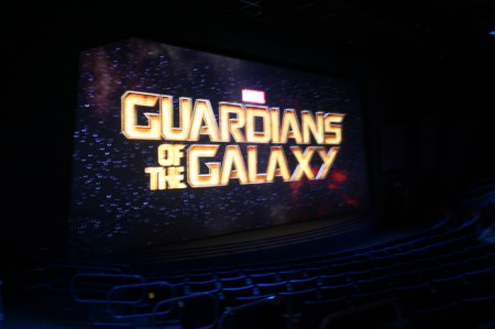 Inside the theater, the screen is filled with the title of the film.
