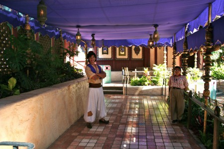 Aladdin waits to greet guests in his Oasis in Adventureland