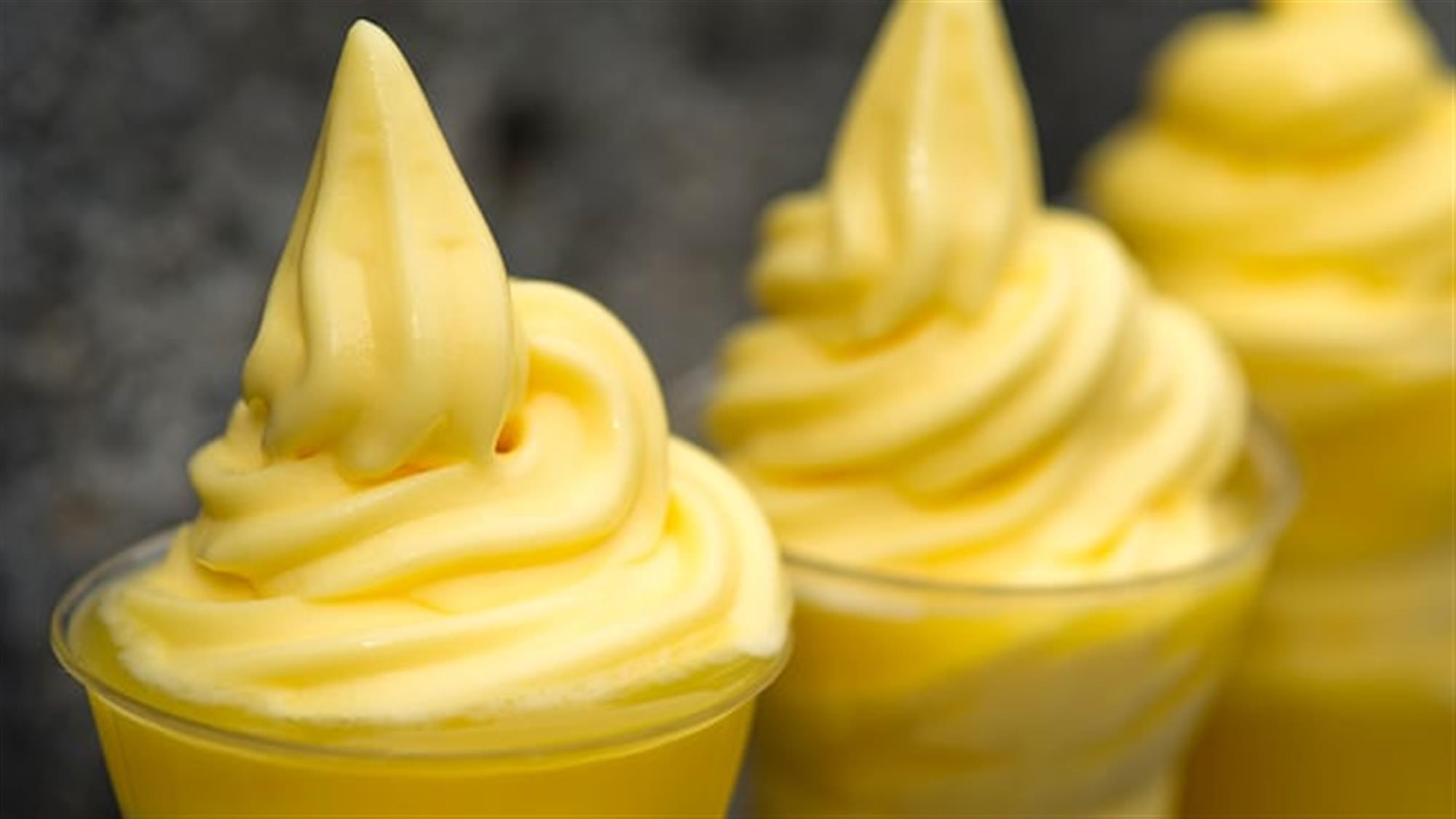 Three cups filled with soft-serve Dole Whip at Aloha Isle in Magic Kingdom park
