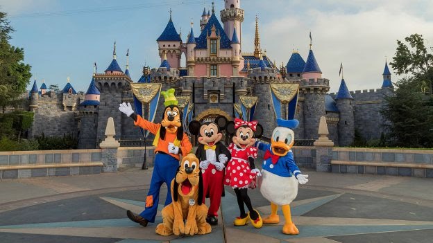 Standing in front of Sleeping Beauty Castle at Disneyland Park, Mickey Mouse, Minnie Mouse, Donald, Pluto and Goofy